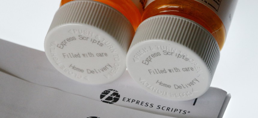 Express Scripts prescription medication bottles are arranged for a photo. 
