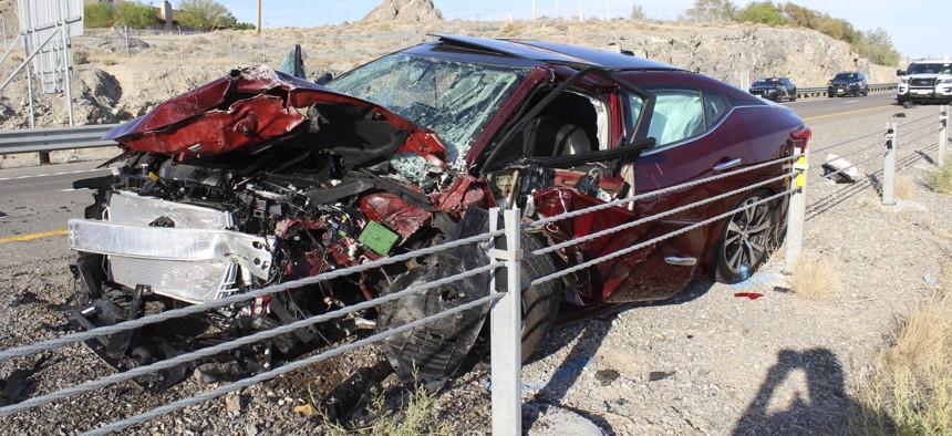 A smashed up vehicle sits on the shoulder of Interstate 80 in West Wendover, Nevada, following a crash that claimed at least two lives, in which one vehicle was traveling the wrong direction on the highway.