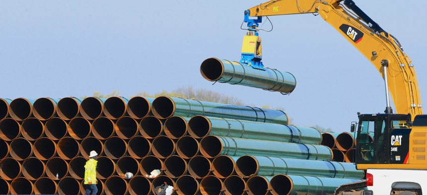  In this May 9, 2015 file photo, pipes for the proposed Dakota Access Pipeline are stacked at a staging area in Worthing, S.D.