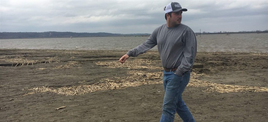 Farmer Trey Garst walks near his family’s flooded 2,400 acres in Watson, Missouri. Because of a flooded wastewater treatment plant about 50 miles north, Omaha, Nebraska’s raw sewage had been dumped into a creek that runs into the nearby Missouri River.
