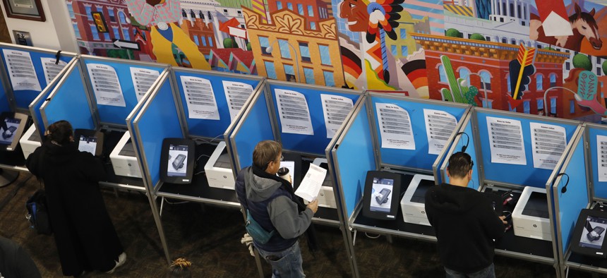 Voters cast their ballot in Denver. Colorado in March became the 14th state to join the National Popular Vote Interstate Compact. 