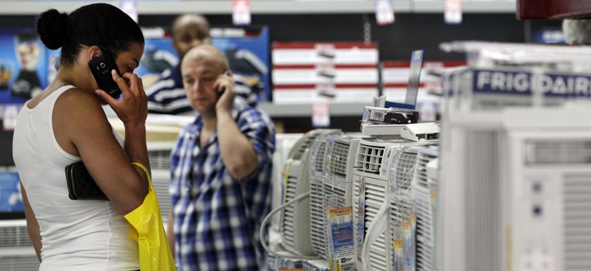 A shopper looks at air conditioners at a store in New York. More states are looking to phase out hydrofluorocarbons, or HFCs, which are pollutants used as refrigerants in air conditioners and refrigerators.