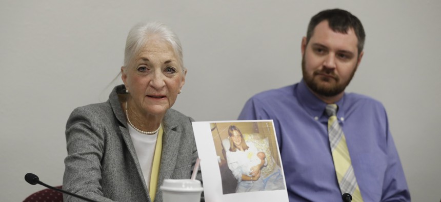 Liz White and her son, Matt White, pushed for a new Indiana law making fertility fraud a crime. Liz White displays a photo of herself and her baby after giving birth.