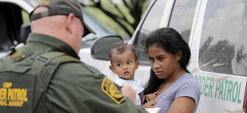 A mother migrating from Honduras holds her 1-year-old child last year while surrendering to U.S. Border Patrol agents after crossing the border near McAllen, Texas.
