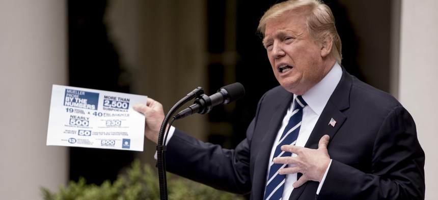 President Donald Trump holds up a stat sheet having to do with the Mueller Report as he speaks in the Rose Garden at the White House in Washington, Wednesday, May 22, 2019.
