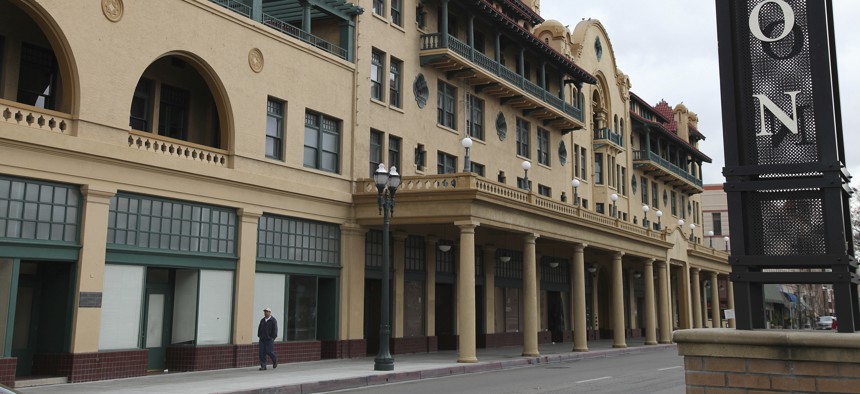  A man walks past the historic Hotel Stockton in Stockton, Calif. 