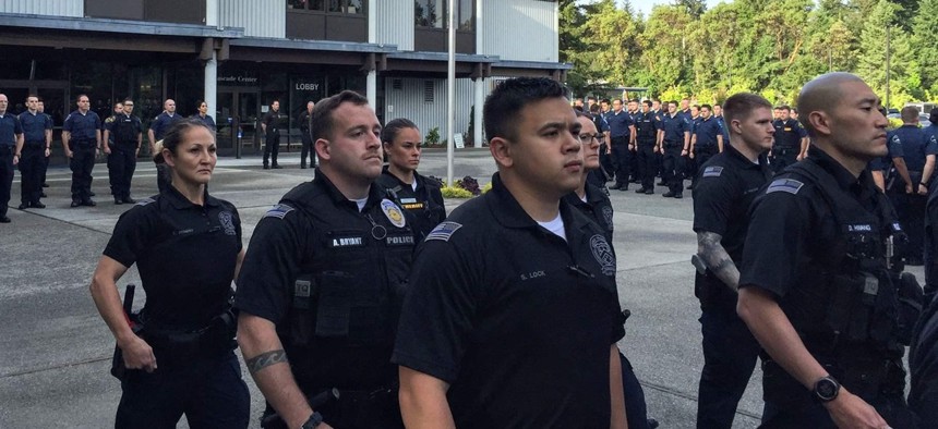 Police recruits gather at the morning flag ceremony at the Washington State Criminal Justice Training Commission. The recruits are trained in mental health and de-escalation.