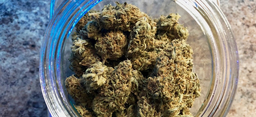 In this April 2019 photo, a jar of medical marijuana sits on the counter at Western Oregon Dispensary in Sherwood, Ore.