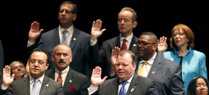 Newly elected aldermen take the oath of office in 2015.