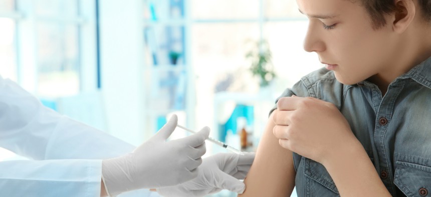 A teen receives a vaccination.