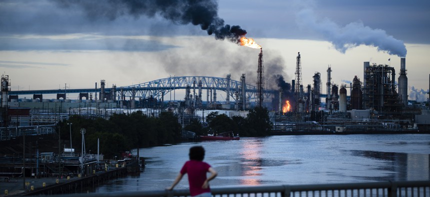 A resident watches the blaze, which continued for over 24 hours.