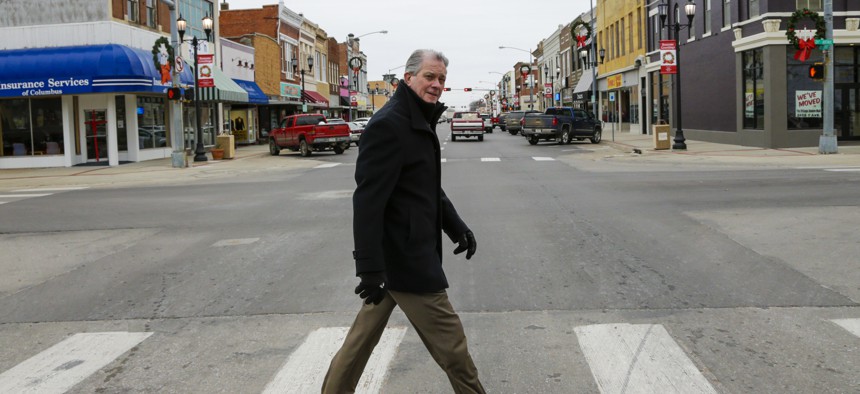 Attorney Thomas Maul crosses 13th Street in downtown Columbus, Nebraska. Maul headed the Nebraska State Bar Association in 2016 and was instrumental in pushing for a program to recruit lawyers to rural areas of the state.