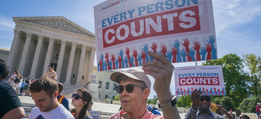In this April 23, 2019 file photo, Immigration activists rally outside the Supreme Court as the justices hear arguments over the Trump administration's plan to ask about citizenship on the 2020 census, in Washington.
