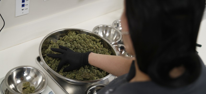 A worker sorts marijuana at the Blum marijuana dispensary in Las Vegas.