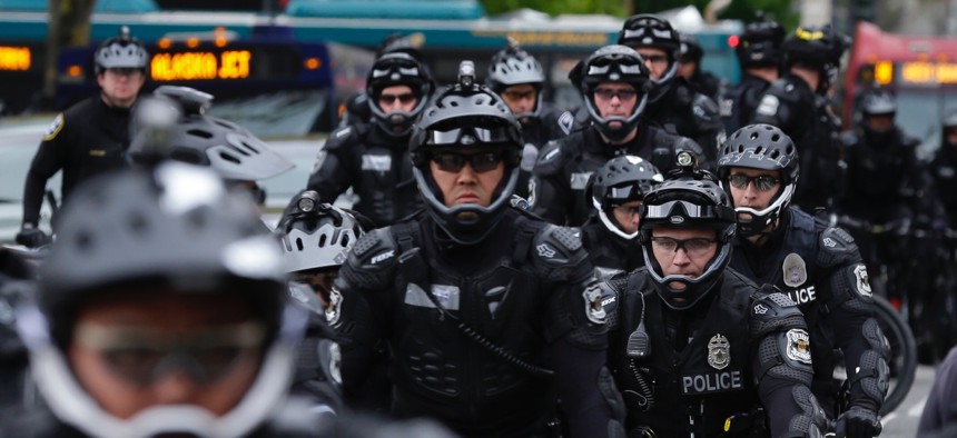 Seattle Police Officers stage near a May Day protest in Seattle. Immigrant and union groups marched in cities across the United States on Monday, to mark May Day and protest against President Donald Trump's efforts to boost deportation.