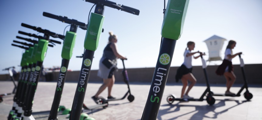 Lime e-scooters lined up in San Diego.