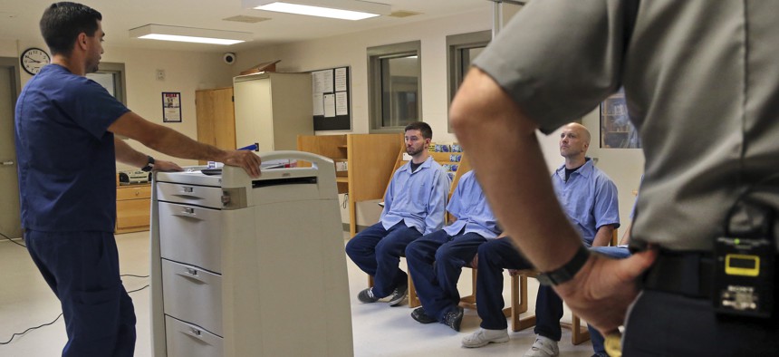 Several Franklin County Jail inmates are watched by a nurse and a corrections officer after they received their daily doses of buprenorphine, a drug which controls heroin and opioid cravings. 