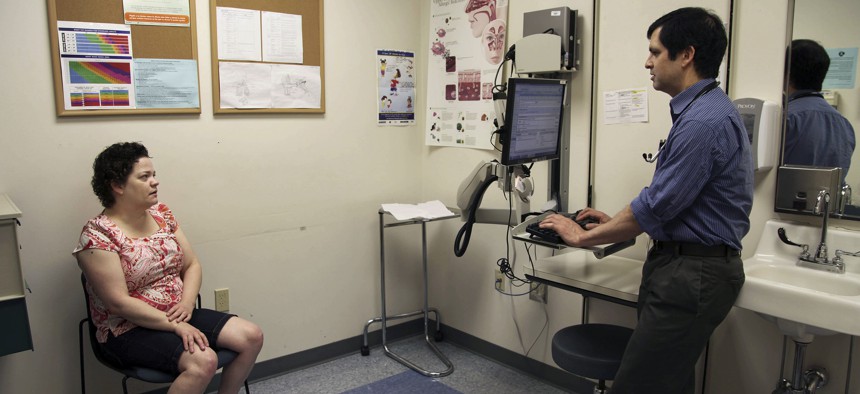 A patient speaks with a primary care doctor at a clinic run by the Virginia Garcia Memorial Health Center in Beaverton, Ore. 