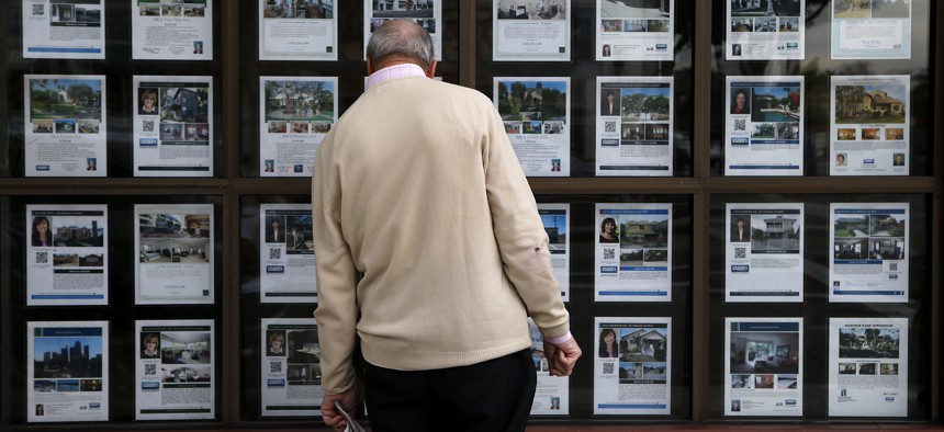 A man looks at listings of homes for sale in Los Angeles.