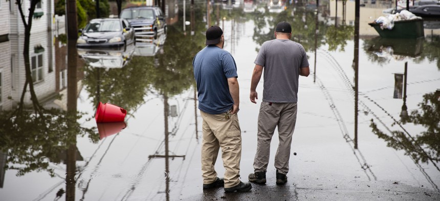People inspect the floodwaters submerging Broadway in Westville, N.J. Thursday, June 20, 2019. Severe storms containing heavy rains and strong winds spurred flooding across southern New Jersey.