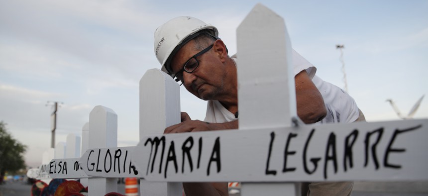 Greg Zanis prepares crosses to place at a makeshift memorial for victims of a mass shooting at a shopping complex Monday, Aug. 5, 2019, in El Paso, Texas. 