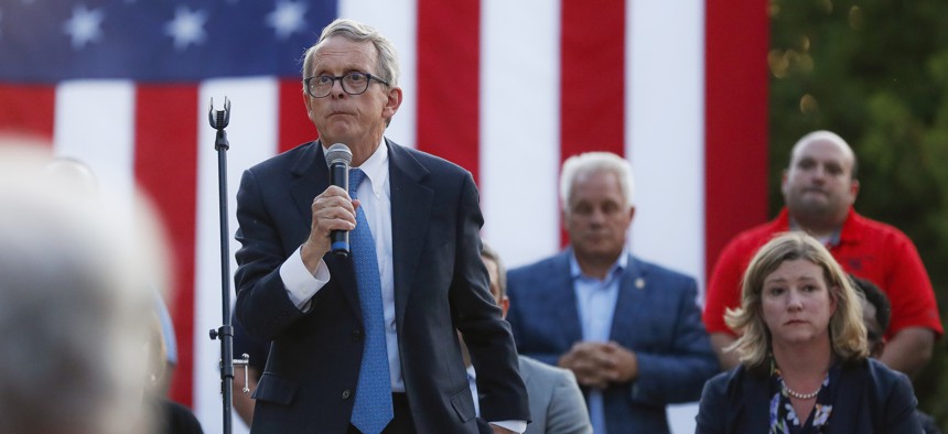 Ohio Gov. Mike DeWine, left, speaks alongside Dayton Mayor Nan Whaley, right, during a vigil at the scene of a mass shooting, Sunday, Aug. 4, 2019, in Dayton, Ohio.