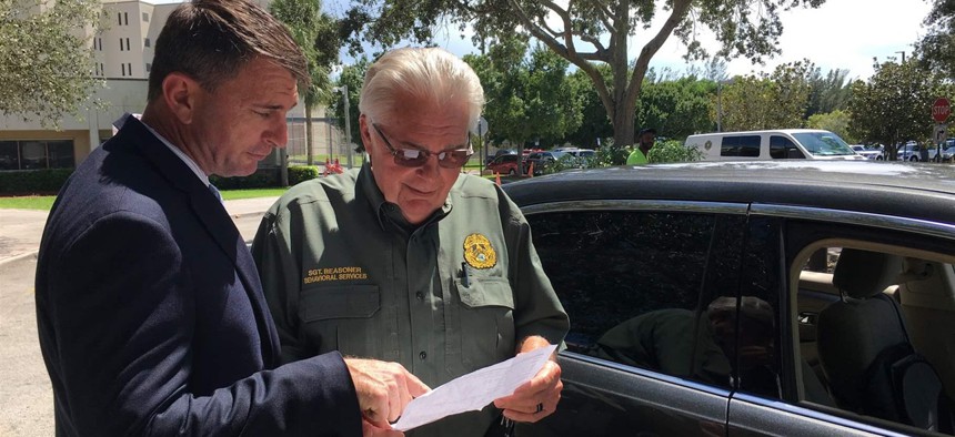 Lt. Randy Foley, left, and Sgt. Skip Reasoner at the Palm Beach County Sheriff’s Office in West Palm Beach, Florida. Nationwide, few police departments have enough trained staff to respond to tips on potentially violent people.