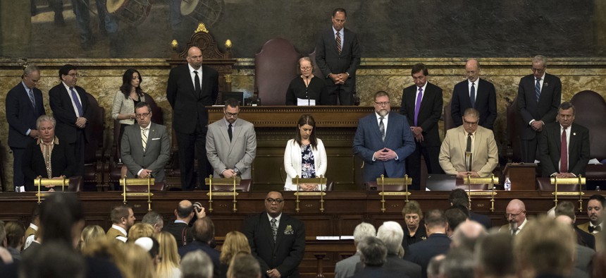 Legislators pray before a joint session of the Pennsylvania legislature.