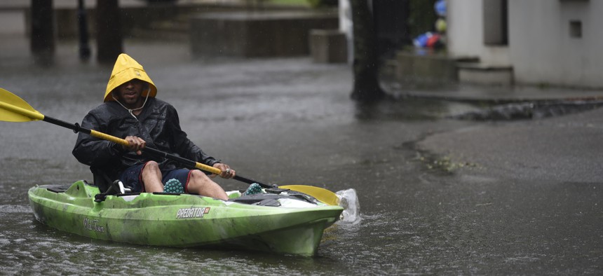 Johnny Crawford navigates his kayak down a flooded street, Thursday, Sept. 5, 2019, in Charleston, S.C., following Hurricane Dorian. The downtown neighborhood is prone to floodwaters, even without a tropical weather event. 
