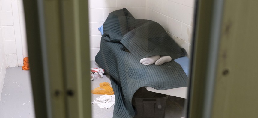 An inmate shown covered in a tear-resistant blanket sleeps at the Lake County Jail in Lakeport, California. These blankets were one of the many changes at the jail after a 2015 suicide there resulted in a $2 million wrongful death settlement.