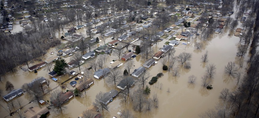 In this aerial photo, houses are surrounded by floodwater, Thursday, Dec. 31, 2015, in Arnold, Mo. 