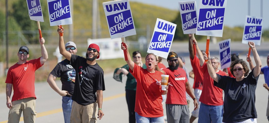 Striking plant workers cheer outside the General Motor assembly plant in Bowling Green, Kentucky.