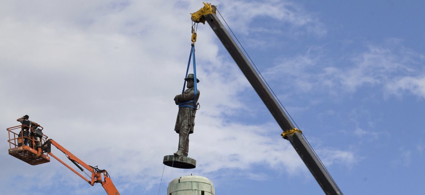 In this May 19, 2017 photo, a statue of Confederate General Robert E. Lee is removed from Lee Circle in New Orleans. 