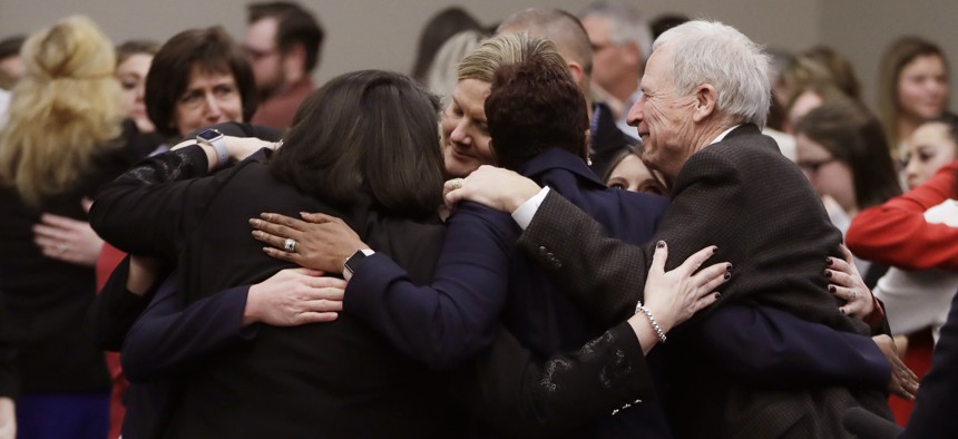 Victims and supporters embrace after Larry Nassar was sentenced to 40 to 175 years in prison in January 2018.