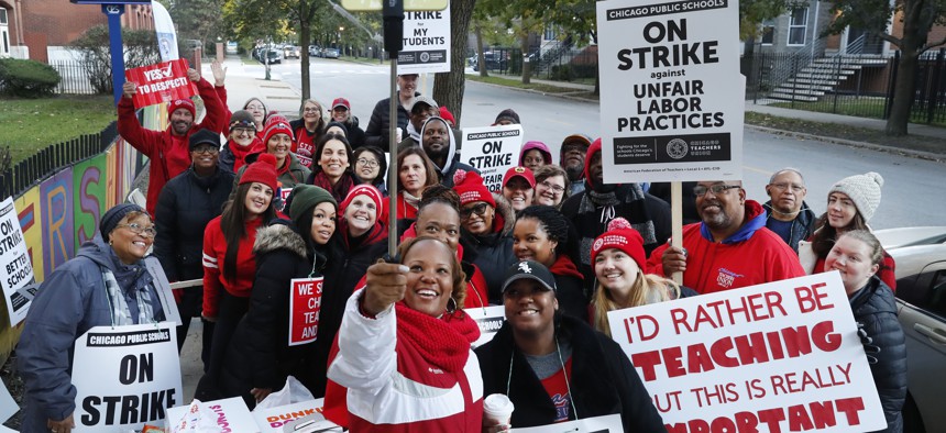 Striking teachers and support staff pose for a group shot in Chicago.
