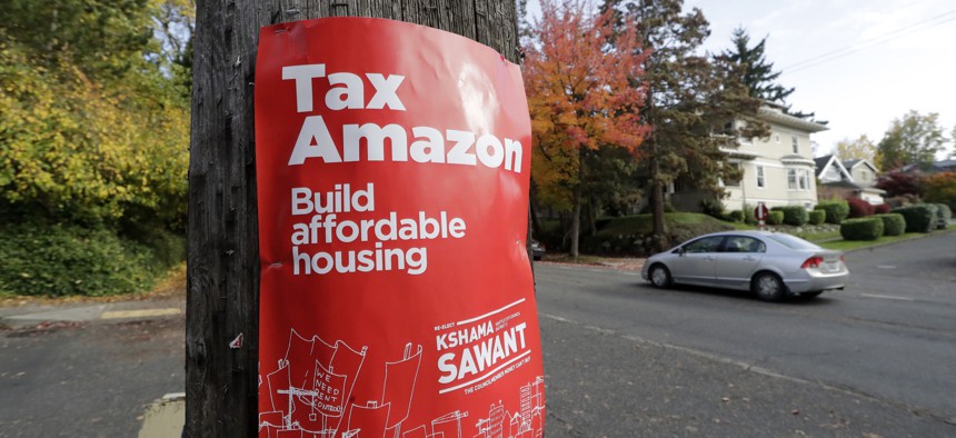 A poster for Seattle city councilmember Kshama Sawant that reads "Tax Amazon."