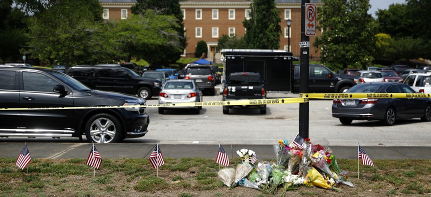 The day after a mass shooting in Virginia Beach, Virginia, a makeshift memorial was created at the edge of a police cordon in front of a municipal building.