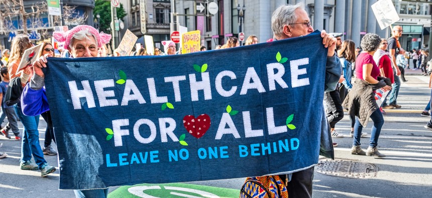 Participants to the Women's March event carry "Healthcare for all" sign while marching on Market street in downtown San Francisco in January 2019.