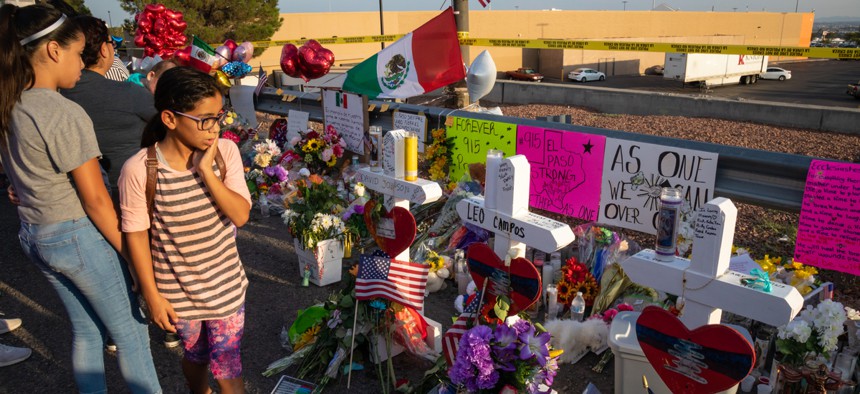 Mourners stand by memorials to the 22 people killed in a mass shooting in El Paso, Texas in August. The FBI data showed a 14% rise in anti-Latino hate crimes, the third year of increases of these types of offenses.