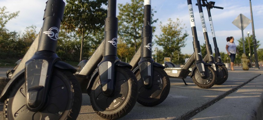 Sharable electric scooters by Bird Rides, Inc. wait on downtown sidewalks for pedestrian use, Wednesday, Oct. 2, 2019, in downtown Cincinnati. 