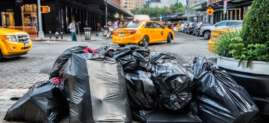New York City Mayor Bill de Blasio signed a law this week to place new regulations on commercial trash collection in the city. 