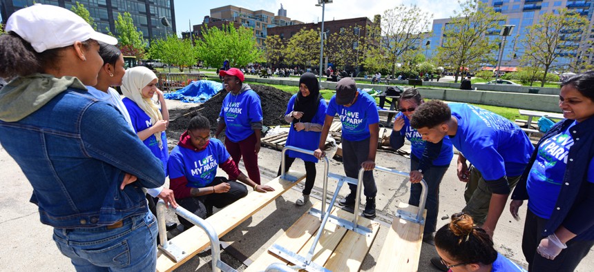 AmeriCorps volunteers set up benches in a park in New York. Advocates want to see programs such as AmeriCorps expanded in rural communities. 