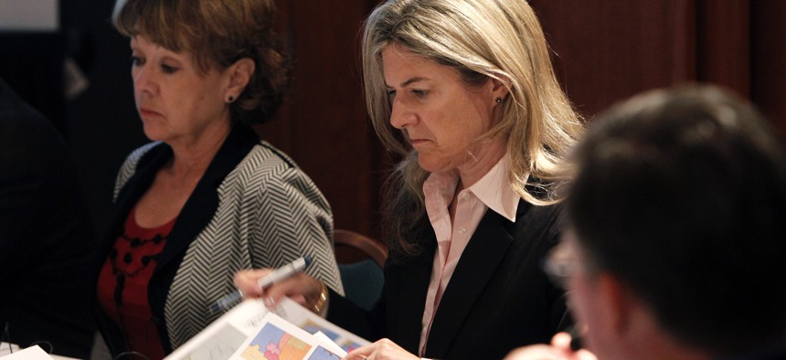 Colleen Coyle Mathis examines redistricting maps at a meeting of the Arizona Independent Redistricting Commission in Tempe in 2011. As chairwoman of the panel, Mathis was attacked by state politicians and members of the public.