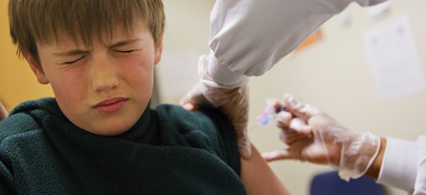 Reed Olson, 8, gets a flu shot at a Dekalb County health center in Decatur, Ga., Monday, Feb. 5, 2018. 