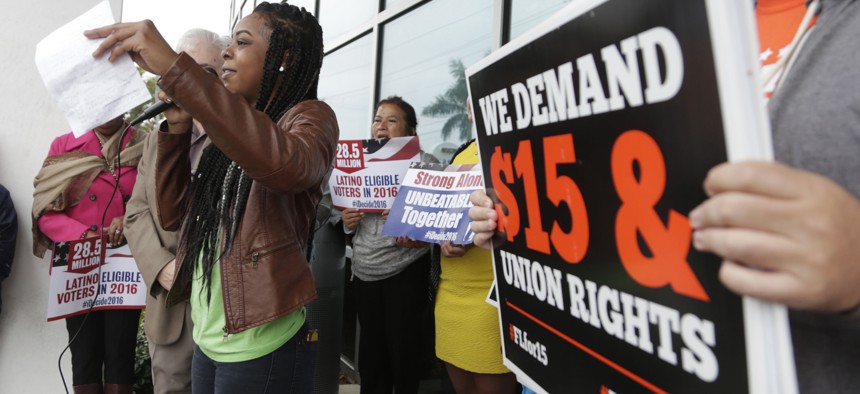 Protestors in Florida call for a higher minimum wage and other legislation during 2016 in Florida. The state is one of about two dozen around the U.S. that have statutes restricting local minimum wage laws.