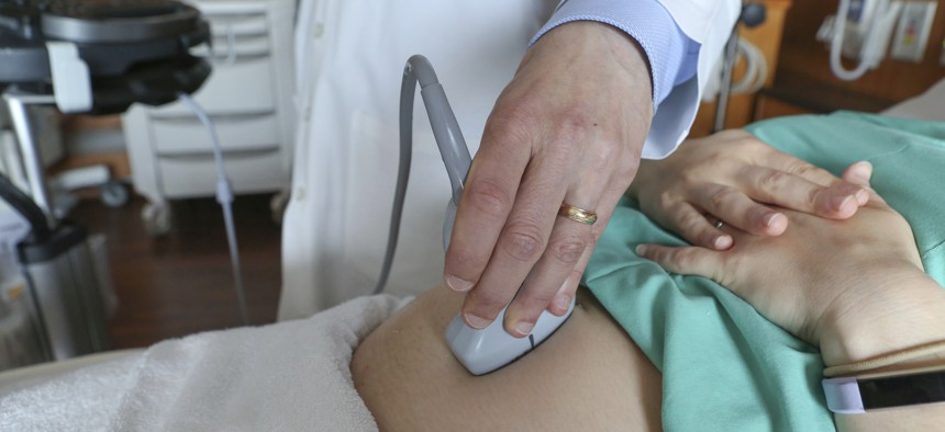 A doctor performs an ultrasound. Under a Pennsylvania bill, fetal death would be defined as any time after conception.