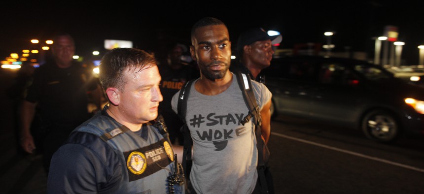 Police officers arrest DeRay Mckesson for blocking Airline Highway during a protest in Baton Rouge, La.