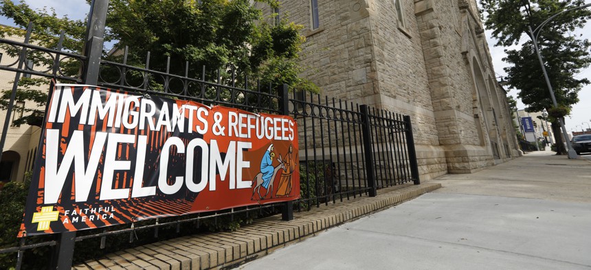 A sign hangs outside Central Presbyterian Church in Atlanta welcoming immigrants and refugees. Atlanta will continue to resettle refugees in 2020.