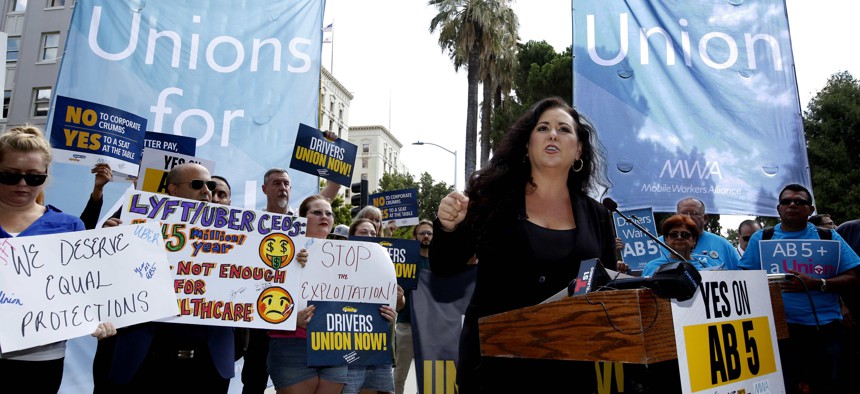 In this Aug. 28, 2019, file photo, Assemblywoman Lorena Gonzalez, D-San Diego, speaks at rally calling for passage of her measure to limit when companies can label workers as independent contractors at the Capitol in Sacramento, Calif.