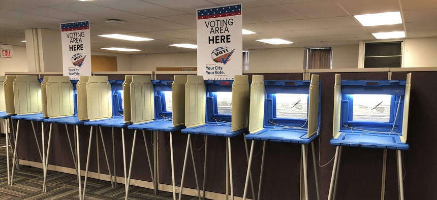 In this Sept. 20, 2018 photo, voting booths stand ready in downtown Minneapolis for the opening of early voting in Minnesota. 